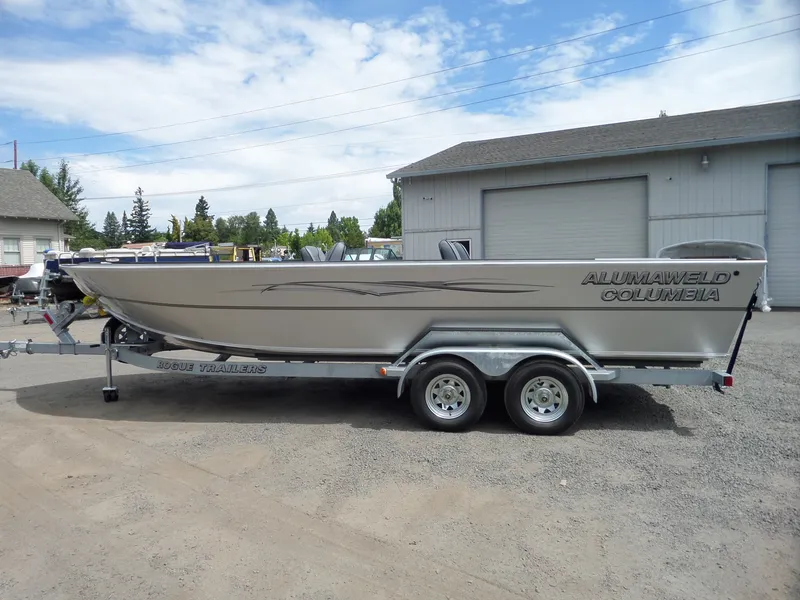 Slide: The Image of 2018 Alumaweld Columbia boat on Rogue Trailers under a partly cloudy sky. - 5