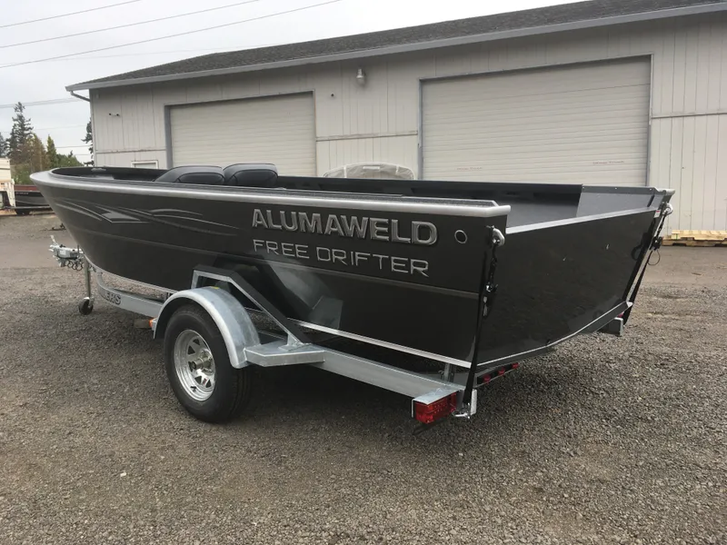 Slide: The Image of 2018 Alumaweld Free Drifter boat on a trailer, parked outside a garage. - 8