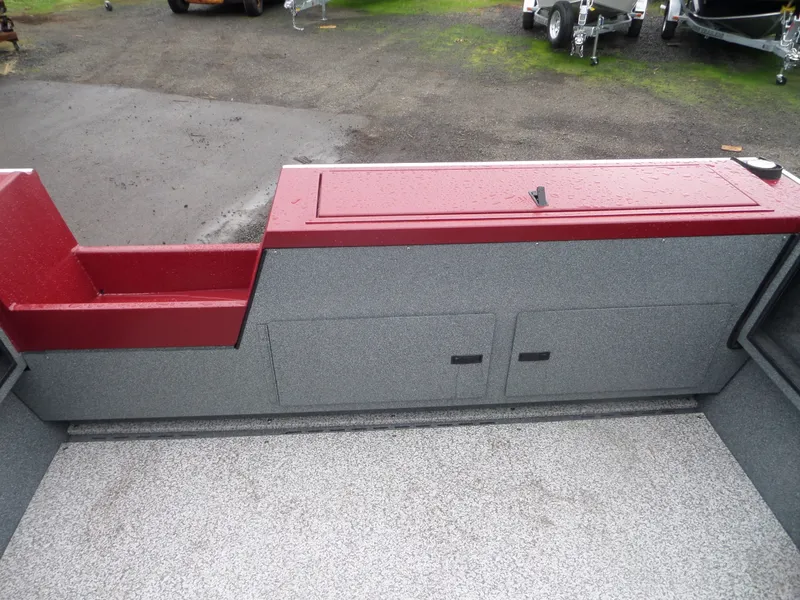 Slide: The Image of 2018 Alumaweld Intruder boat interior with red and gray storage compartments. - 10