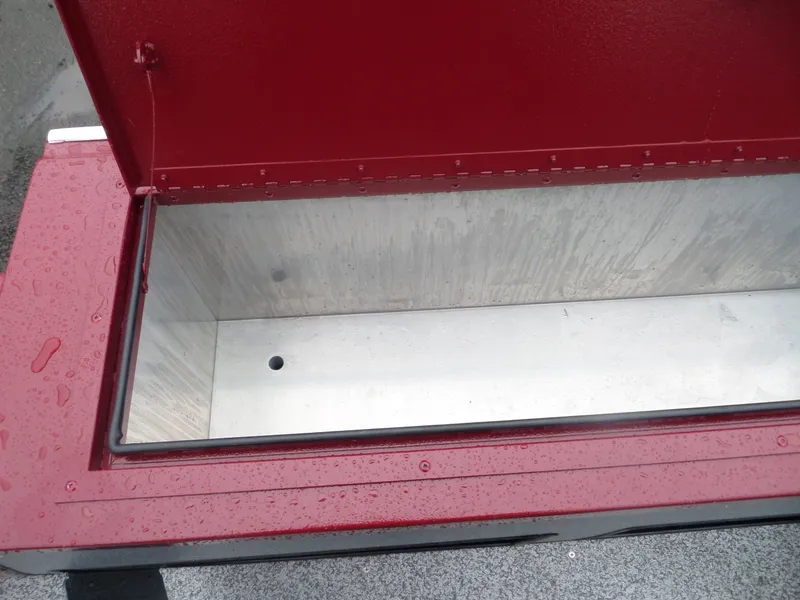 Slide: The Image of Open storage compartment of 2018 Alumaweld Intruder boat with red exterior. - 12