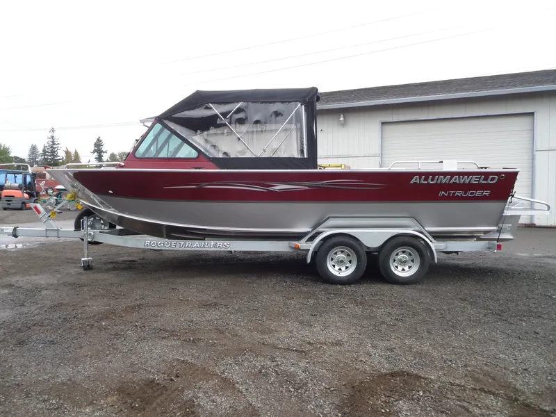 Slide: The Image of 2018 Alumaweld Intruder boat on Rogue Trailers, parked outside a warehouse. - 5