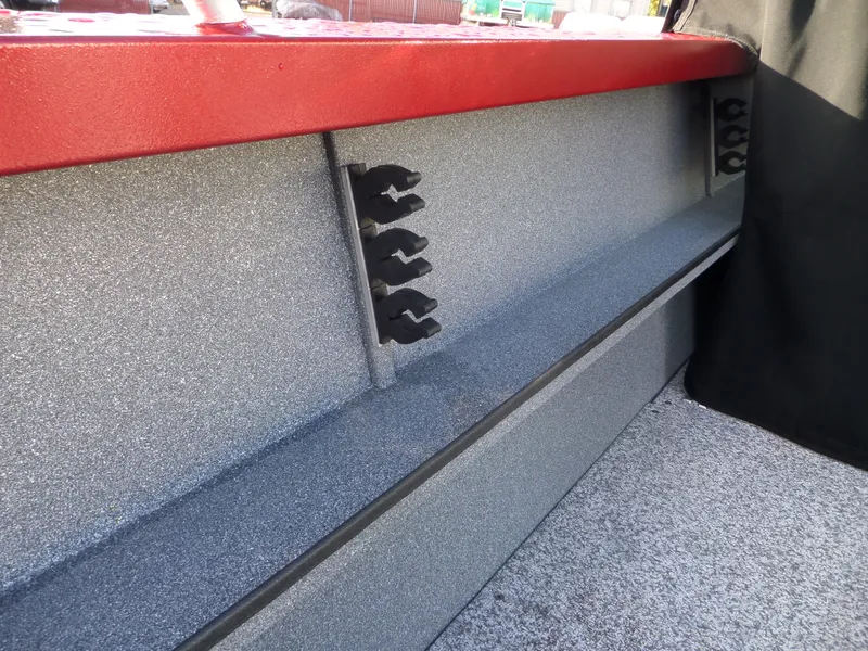 Slide: The Image of 2018 Alumaweld Stryker boat interior with rod holders and red trim. - 12