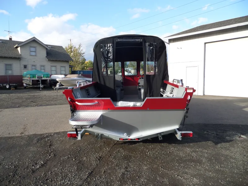 Slide: The Image of 2018 Alumaweld Stryker boat, rear view, parked outdoors near other boats. - 7