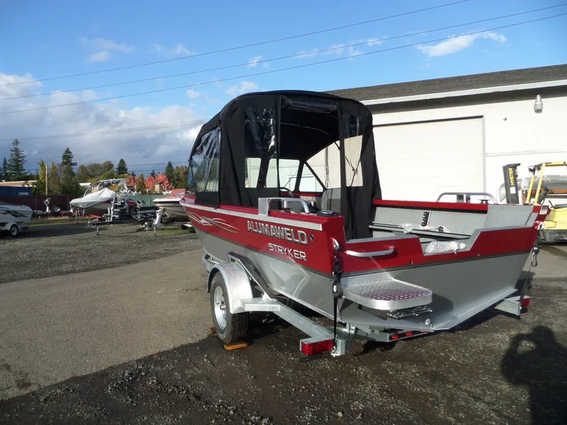 Slide: The Image of 2018 Alumaweld Stryker boat in a parking lot with other boats. - 8