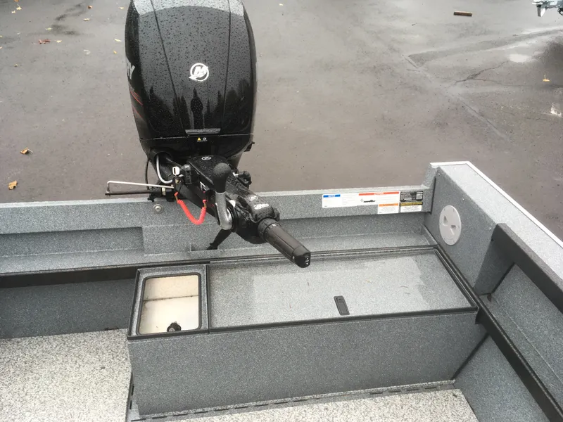 Slide: The Image of 2018 Alumaweld Super Vee boat with Mercury outboard motor on wet pavement. - 11