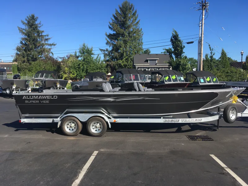 Slide: The Image of 2018 Alumaweld Super Vee Pro boat on a Rogue trailer in a parking lot. - 3