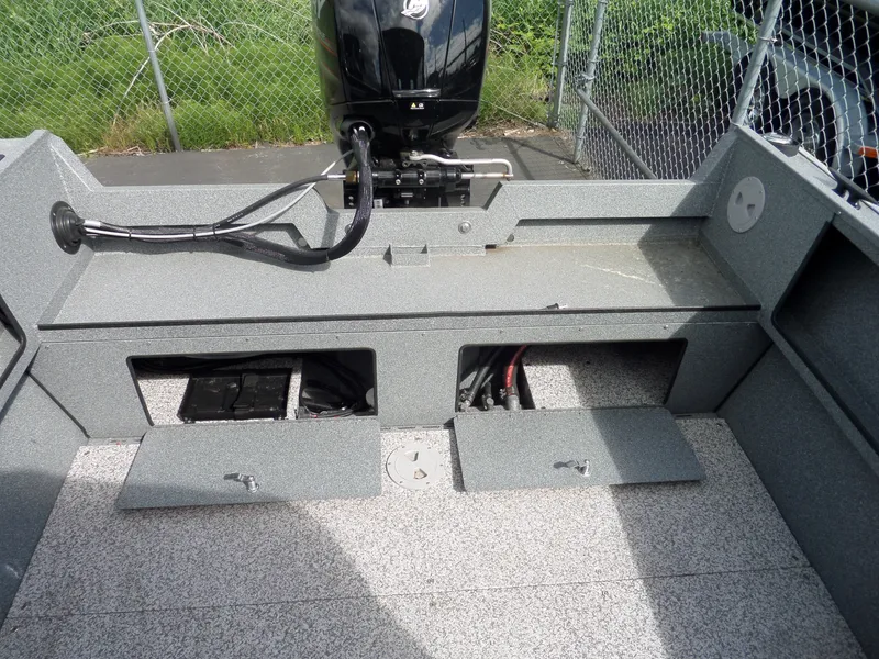 Slide: The Image of 2017 Alumaweld BLACKHAWK JET boat with open storage compartments and motor. - 12