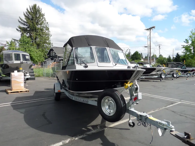 Slide: The Image of 2017 Alumaweld BLACKHAWK JET boat on trailer in parking lot. - 3