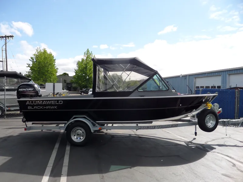 Slide: The Image of 2017 Alumaweld Blackhawk Jet boat on Rogue trailer in parking lot. - 4