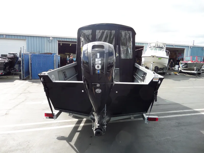 Slide: The Image of 2017 Alumaweld BLACKHAWK JET boat with 150 HP Mercury engine, rear view in a marina. - 6