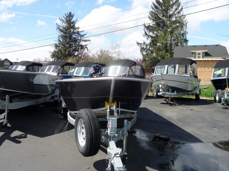 Slide: The Image of 2017 Alumaweld Free Drifter boats on trailers in a parking lot. - 3