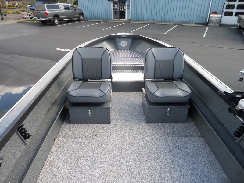 Slide: The Image of 2017 Alumaweld Free Drifter boat interior with two gray seats in parking lot. - 6