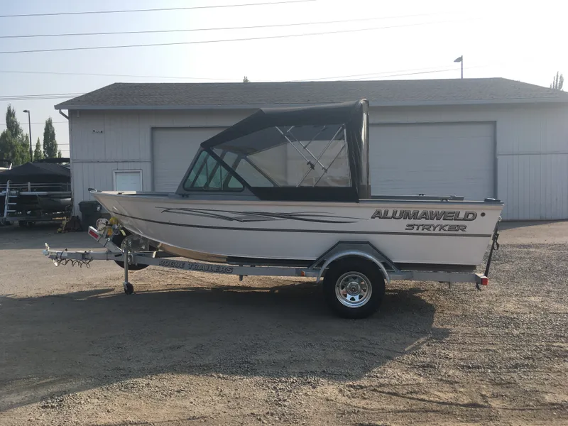 Slide: The Image of 2017 Alumaweld Stryker boat on Rogue trailer outside a garage. - 5