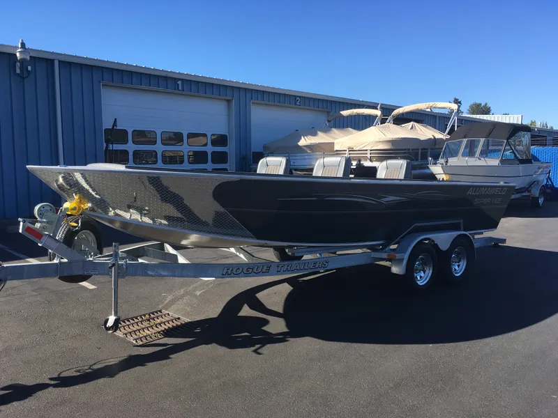 Slide: The Image of 2017 Alumaweld Super Vee Pro boat on Rogue trailer outside blue garage. - 5