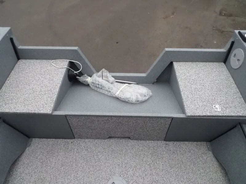 Slide: The Image of 2017 Alumaweld TALON boat interior with storage compartments and wrapped equipment. - 11