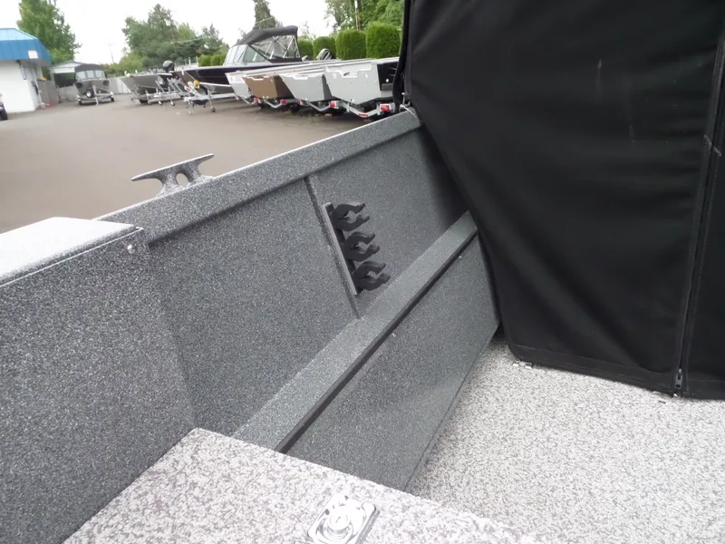 Slide: The Image of 2017 Alumaweld TALON boat interior with rod holders and covered seating. - 9