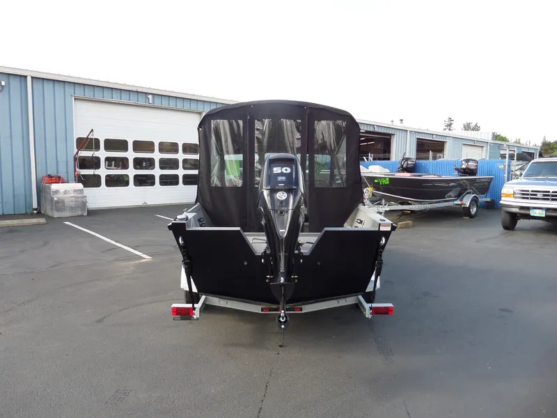 Slide: The Image of 2017 Alumaweld TALON boat on trailer, rear view, parked outside a blue building. - 11