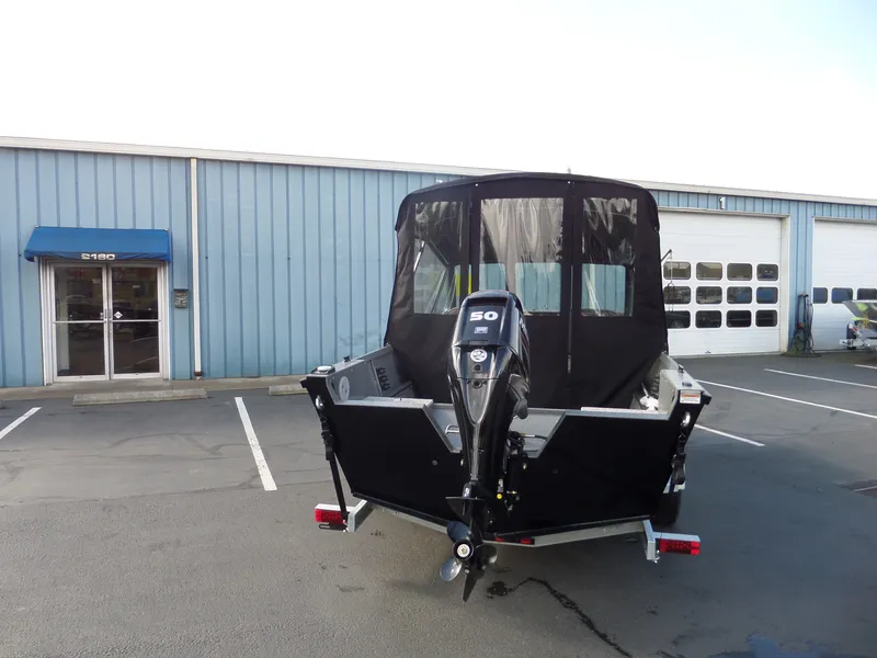 Slide: The Image of 2017 Alumaweld TALON boat with 50 HP motor in front of a blue building. - 3