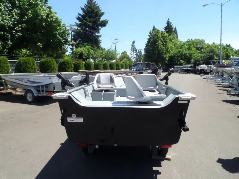 Slide: The Image of 2017 Smoker Craft Alaskan boat in a dealership lot, rear view. - 10