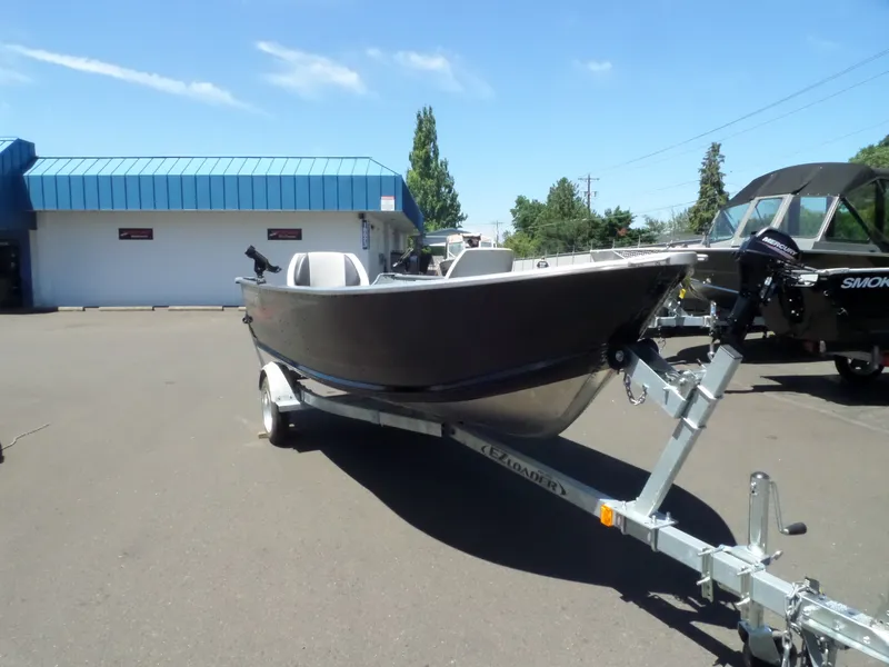 Slide: The Image of 2017 Smoker Craft Alaskan boat on trailer in outdoor dealership lot. - 7
