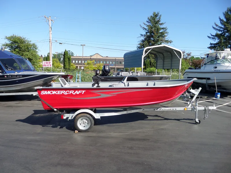 Slide: The Image of 2017 Smoker Craft Alaskan boat in red on a trailer at a dealership. - 1