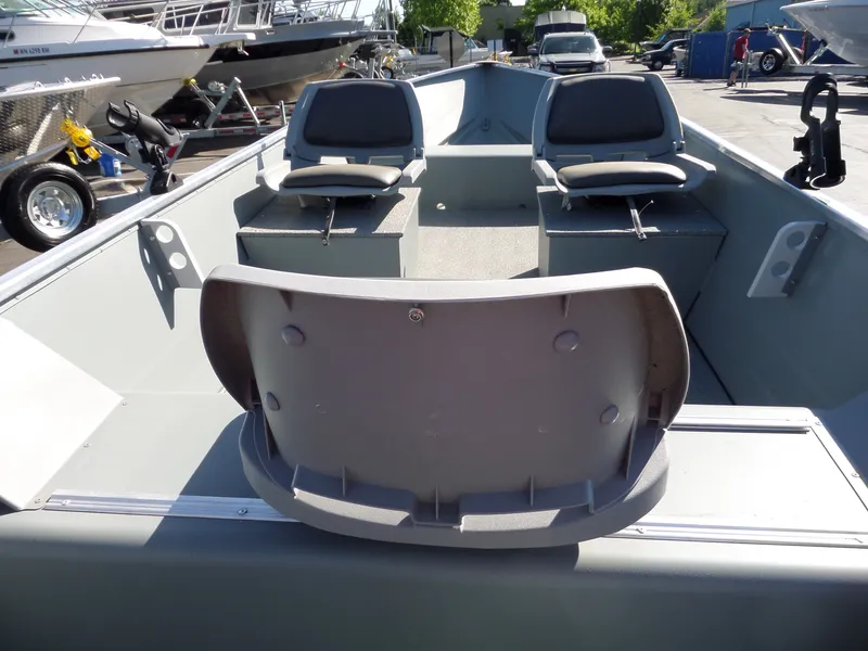 Slide: The Image of 2017 Smoker Craft Alaskan boat interior with seating and storage compartments. - 10