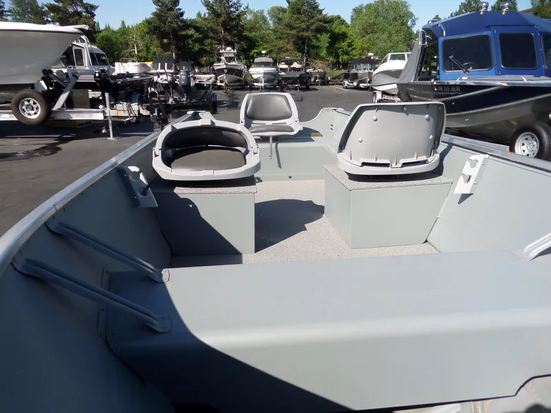 Slide: The Image of 2017 Smoker Craft Alaskan boat interior with seating and storage compartments. - 8