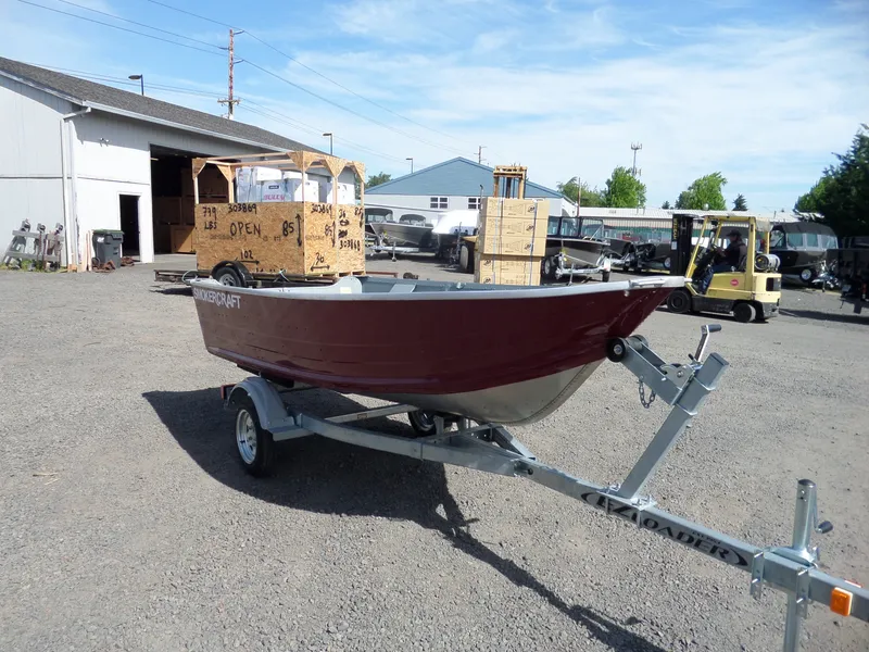 Slide: The Image of 2017 Smoker Craft Alaskan boat on trailer in a warehouse yard. - 3