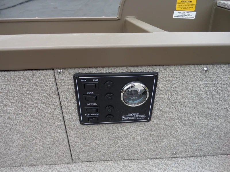 Slide: The Image of Control panel of a 2017 Smoker Craft Freedom boat with fuel gauge and switches. - 12