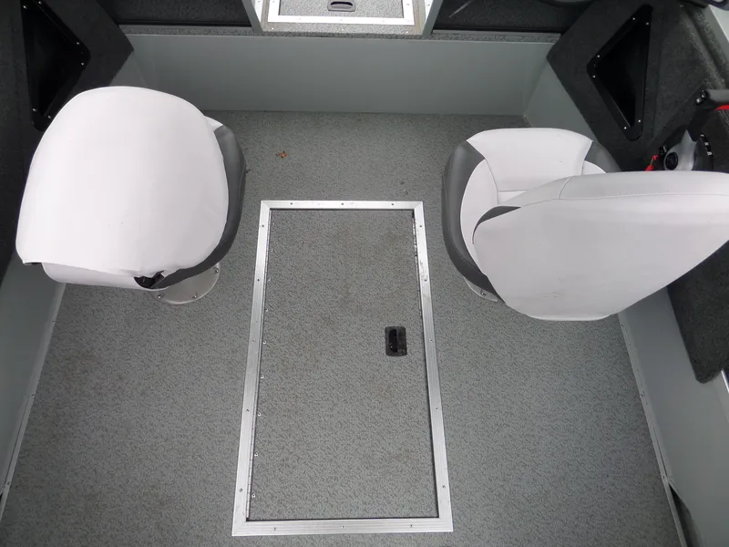 Slide: The Image of Interior of a 2017 Smoker Craft Osprey boat with two white seats and storage hatch. - 10