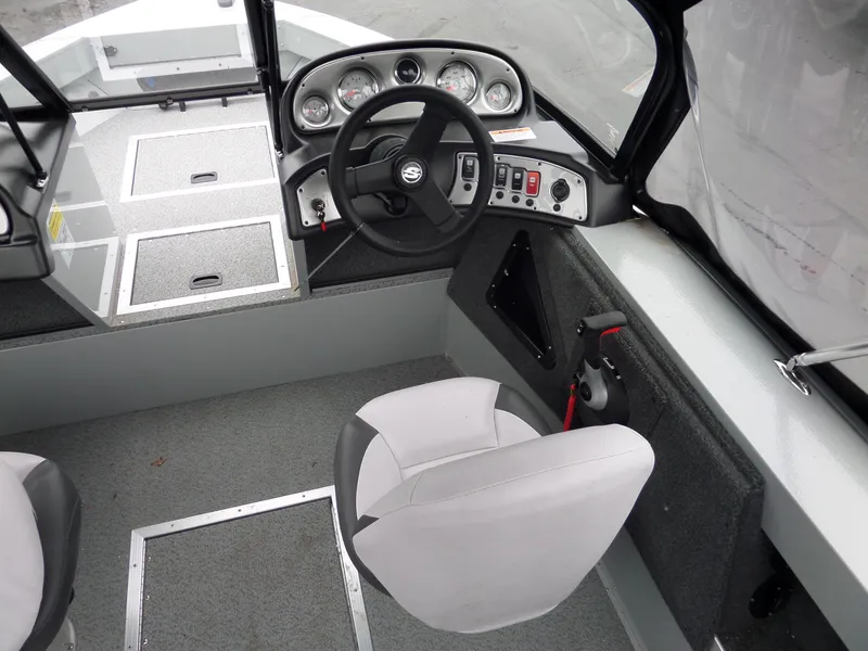 Slide: The Image of 2017 Smoker Craft Osprey boat interior with steering wheel and control panel. - 12