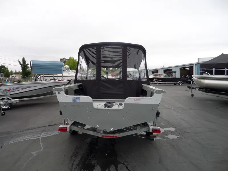Slide: The Image of 2017 Smoker Craft Osprey boat on trailer in a marina parking lot. - 3