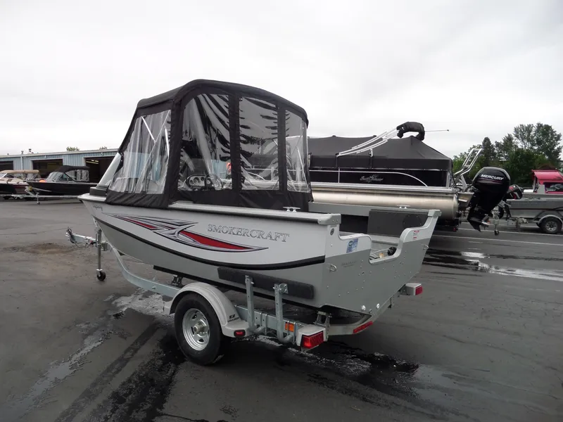 Slide: The Image of 2017 Smoker Craft Osprey boat on trailer with canopy in parking lot. - 4