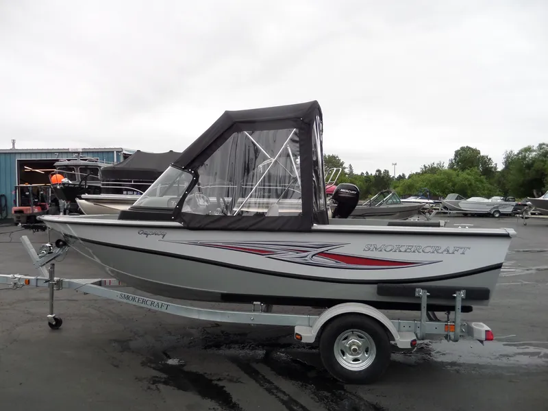 Slide: The Image of 2017 Smoker Craft Osprey boat on trailer in outdoor lot. - 5