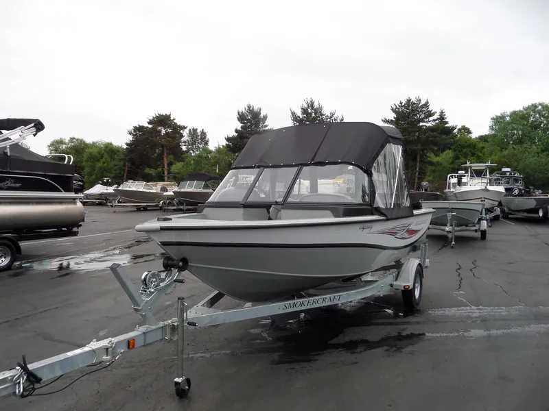 Slide: The Image of 2017 Smoker Craft Osprey boat on trailer in a marina parking lot. - 6