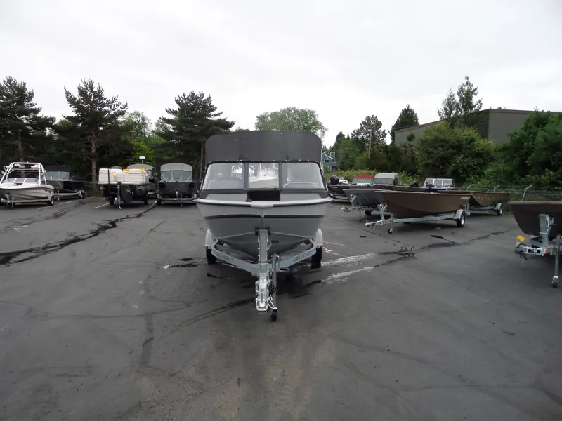 Slide: The Image of 2017 Smoker Craft Osprey boat on trailer in outdoor lot. - 7