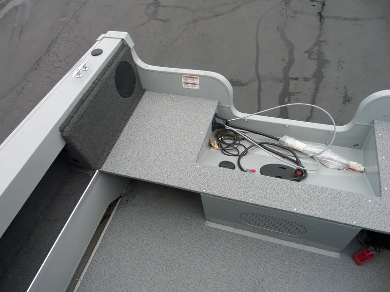 Slide: The Image of 2017 Smoker Craft Osprey boat interior with storage compartment and wiring. - 8