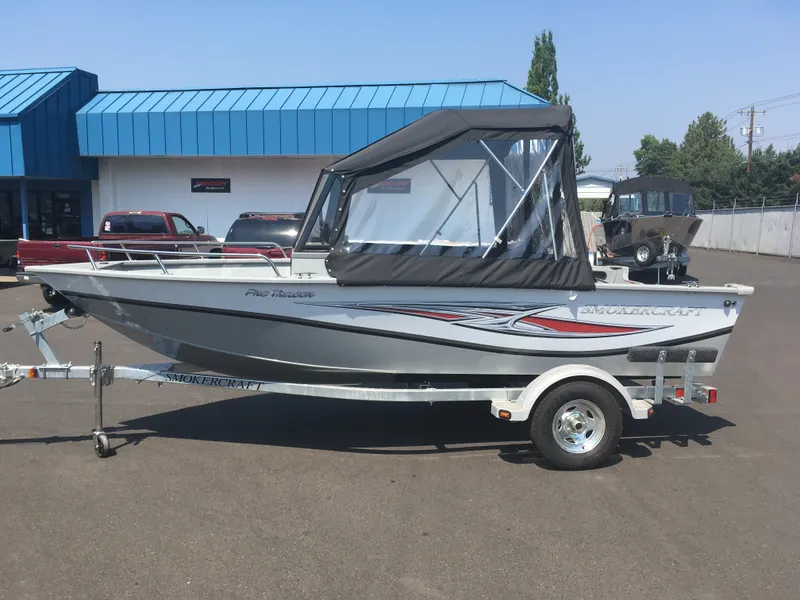 Slide: The Image of 2017 Smoker Craft PRO TRACER boat on trailer outside dealership. - 1