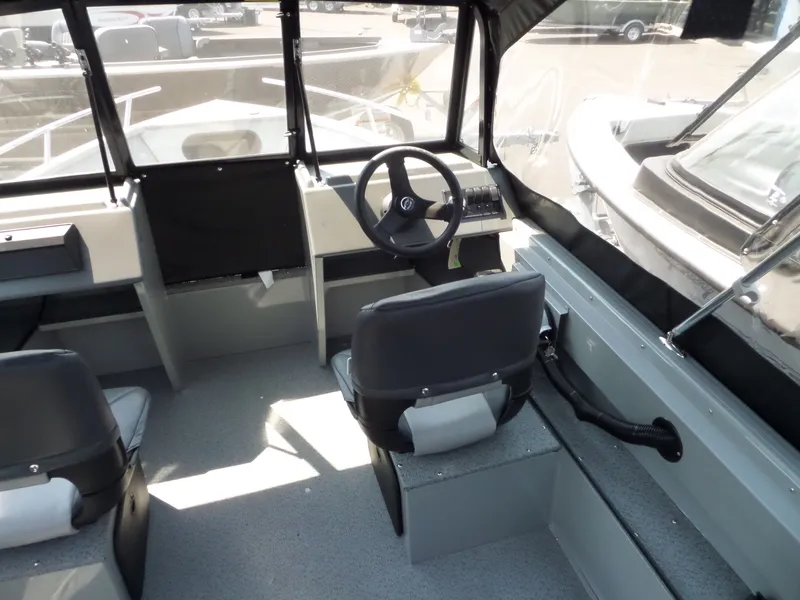 Slide: The Image of Interior of 2017 Smoker Craft PRO TRACER boat with steering wheel and seating. - 11