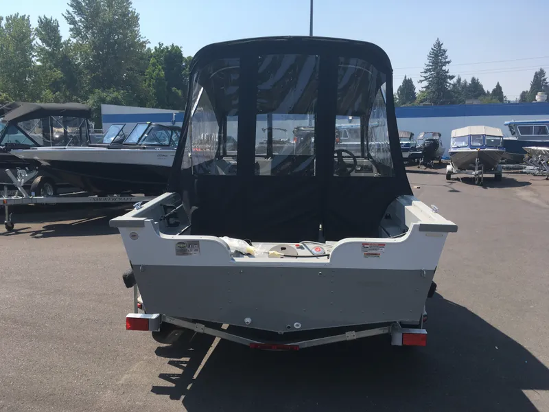 Slide: The Image of 2017 Smoker Craft PRO TRACER boat with canopy in a boatyard. - 3