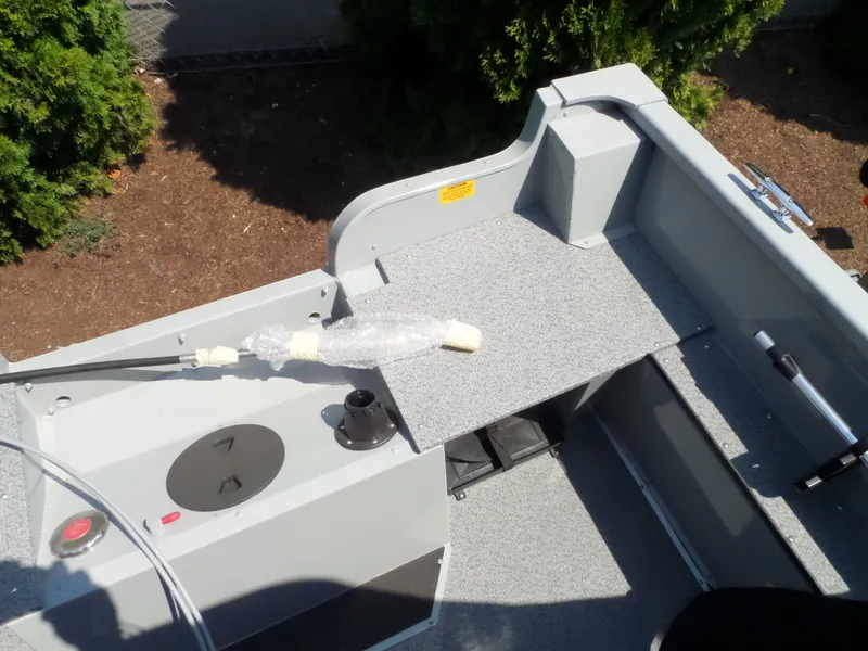 Slide: The Image of 2017 Smoker Craft PRO TRACER boat interior with fishing rod holder and storage compartments. - 9