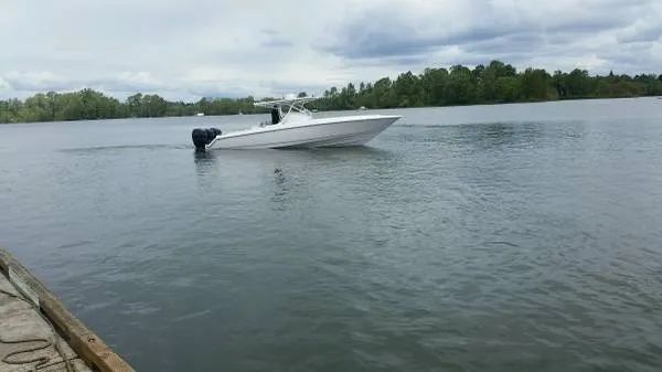 Slide: The Image of 2017 Sonic Center Console High Performance Sport Fish boat on a calm lake. - 12