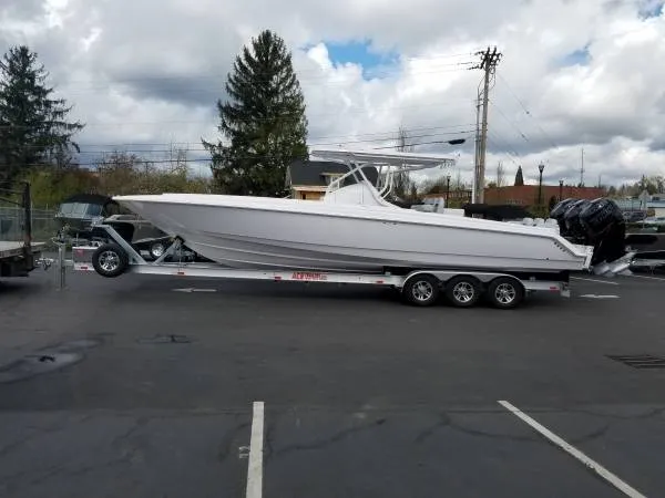 Slide: The Image of 2017 Sonic Center Console High Performance Sport Fish boat on a trailer in a parking lot. - 3