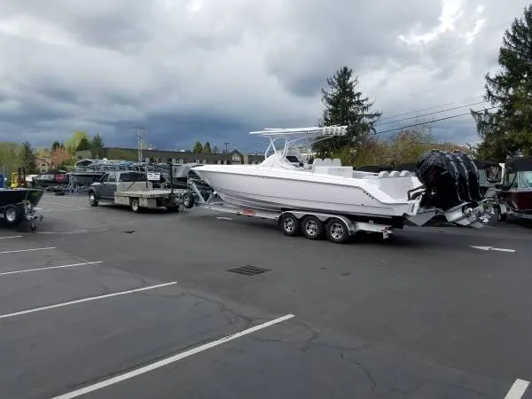 Slide: The Image of 2017 Sonic Center Console High Performance Sport Fish boat on a trailer in a parking lot. - 4