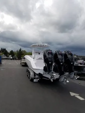 Slide: The Image of 2017 Sonic Center Console High Performance Sport Fish boat with triple outboard engines. - 5