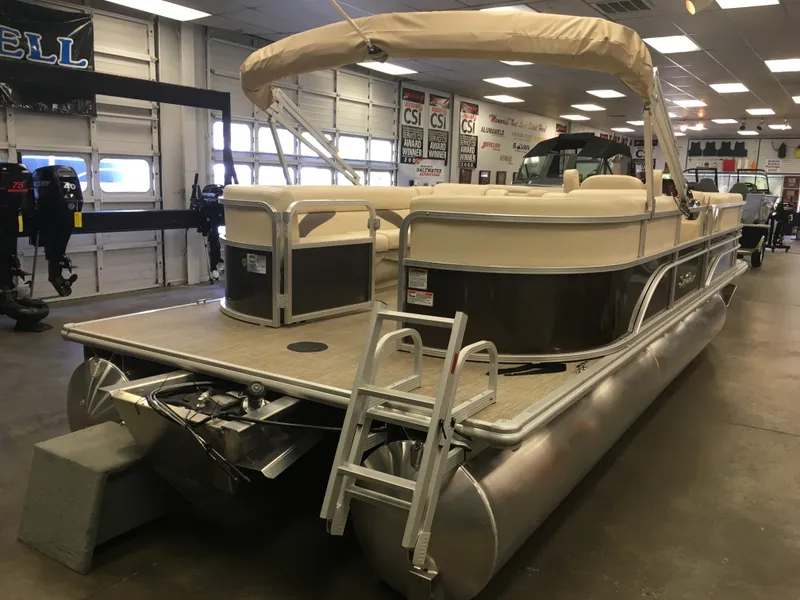Slide: The Image of 2017 SunChaser REAR LOUNGER pontoon boat in showroom with ladder and canopy. - 3
