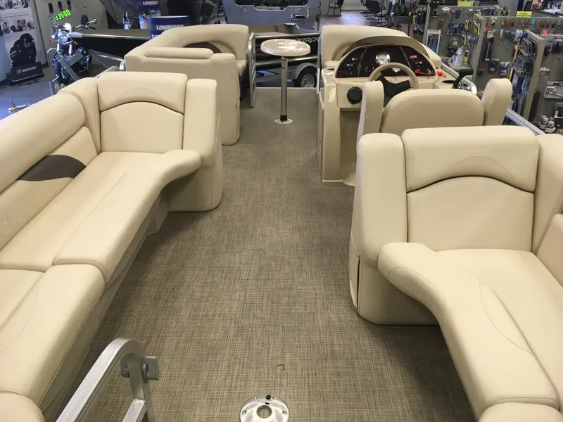 Slide: The Image of 2017 SunChaser REAR LOUNGER pontoon boat interior with beige seating and helm. - 6