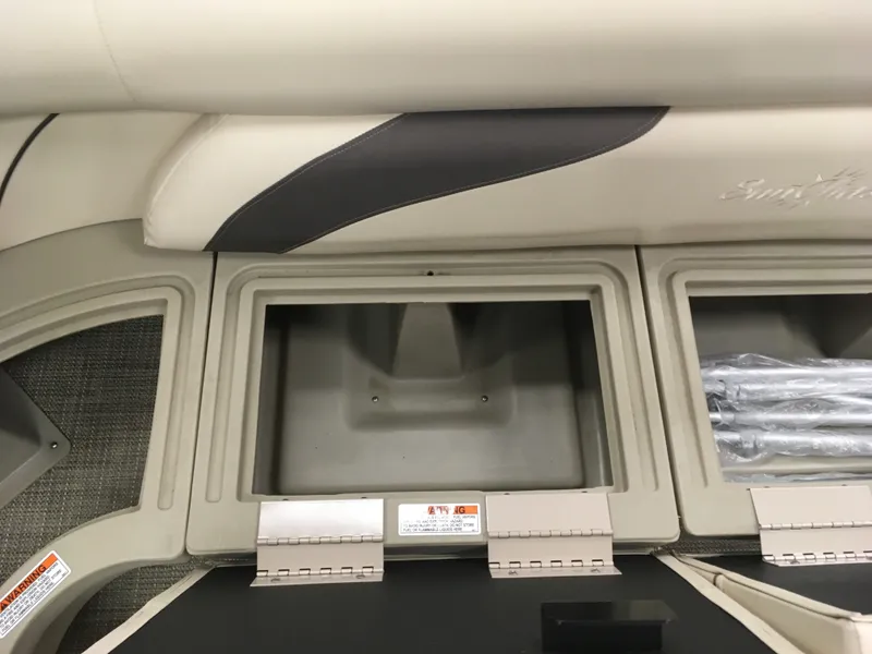 Slide: The Image of 2017 SunChaser REAR LOUNGER storage compartments with open lids. - 8