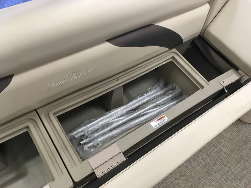Slide: The Image of 2017 SunChaser REAR LOUNGER storage compartment with wrapped metal rods. - 9