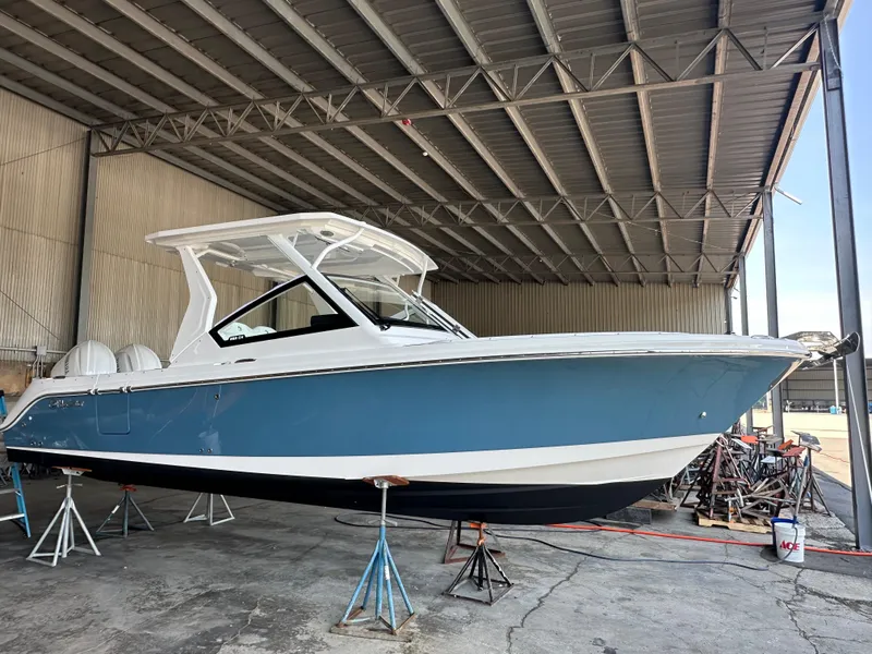 Slide: The Image of 2026 Edgewater 262CX Crossover boat in a covered storage area. - 1